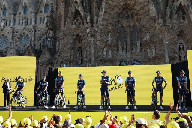 Bahrain - Victorious riders attend the team presentation ceremony ahead of the 113th edition of the Tour de France cycling race, with the Sagrada Familia Basilica  seen in the background, in Barcelona, northeastern Spain, on July 2, 2026. (Photo by Anne-Christine POUJOULAT / AFP)