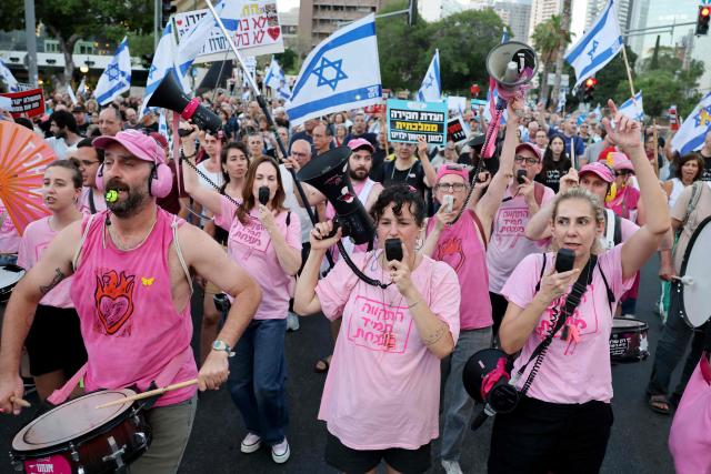 Israeli protesters hold placards and shout slogans during a rally against the government and the war in Gaza, at Hostage Square in Tel Aviv, on July 2, 2026, marking 1000 days since Hamas's October 7, 2023 attack on Israel. Israelis called on July 2 for a state commission of inquiry into Hamas's October 7, 2023 attack, as the country marked 1,000 days since the deadliest event in its history, which triggered the war in Gaza. A series of sombre commemorations were being held across the country, as well as protests against the government's handling of events during and after the attack. (Photo by Jack GUEZ / AFP)
