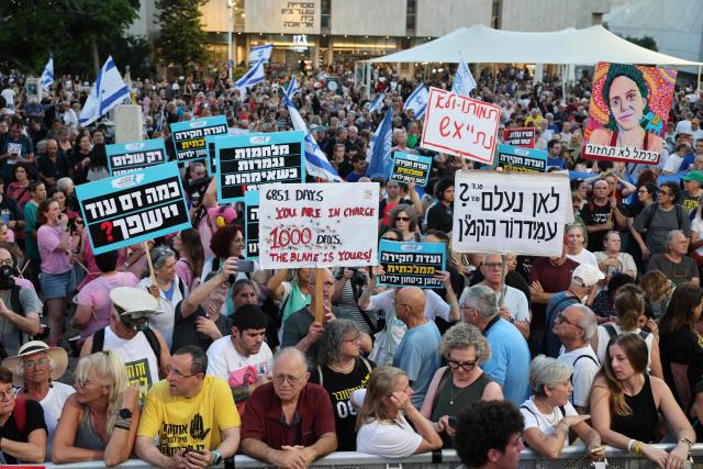 Israeli protesters hold placards during a rally against the government and the war in Gaza, at Hostage Square in Tel Aviv, on July 2, 2026, marking 1000 days since Hamas's October 7, 2023 attack on Israel. Israelis called on July 2 for a state commission of inquiry into Hamas's October 7, 2023 attack, as the country marked 1,000 days since the deadliest event in its history, which triggered the war in Gaza. A series of sombre commemorations were being held across the country, as well as protests against the government's handling of events during and after the attack. (Photo by Jack GUEZ / AFP)
