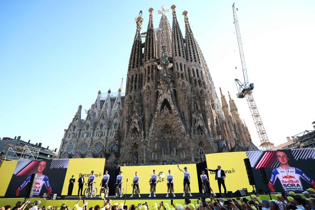 Red Bull - BORA - hansgrohe riders attend the team presentation ceremony ahead of the 113th edition of the Tour de France cycling race, with the Sagrada Familia Basilica  seen in the background, in Barcelona, northeastern Spain, on July 2, 2026. (Photo by Anne-Christine POUJOULAT / AFP)