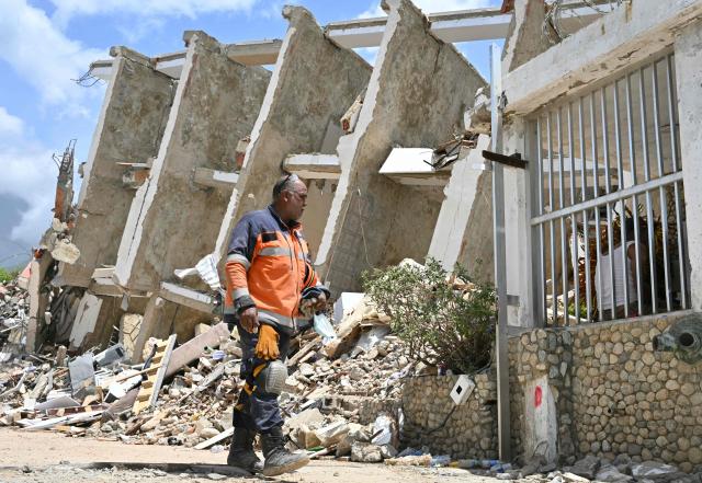 A firefighter takes a break during search operations in Los Corales, Caraballeda, La Guaira state, Venezuela, on July 2, 2026, eight days after twin earthquakes. Hundreds of rescuers in Venezuela cheered and embraced on July 2, 2026 after pulling 43-year-old Hernan Gil from the ruins of a collapsed building eight days after deadly twin earthquakes, AFP journalists witnessed. (Photo by MARTIN BERNETTI / AFP)