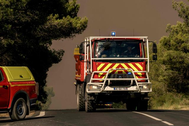 A firefighting vehicle drives during a wildfire in Pouzols-Minervois, southwestern of France,  on July 2, 2026. Hundreds of firefighters are battling wildfires in the south that are being fueled by wind, drought, and heat. The largest fire is in the Aude department, but there are also fires north of Marseille, where Prime Minister is expected to chair a new interministerial crisis task force. (Photo by Idriss Bigou-Gilles / AFP)