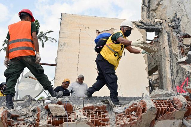 Rescuers work at the site of a collapsed building eight days after twin earthquakes, in Caraballeda, La Guaira state, Venezuela, on July 2, 2026,. More than a week after the earthquakes struck, there is little chance of finding additional survivors from the two earthquakes that killed nearly 2,300 people, destroyed entire residential buildings, and left tens of thousands missing. (Photo by MARTIN BERNETTI / AFP)