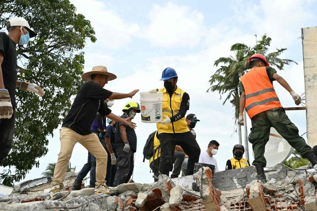 Rescuers work at the site of a collapsed building eight days after twin earthquakes, in Caraballeda, La Guaira state, Venezuela, on July 2, 2026,. More than a week after the earthquakes struck, there is little chance of finding additional survivors from the two earthquakes that killed nearly 2,300 people, destroyed entire residential buildings, and left tens of thousands missing. (Photo by MARTIN BERNETTI / AFP)