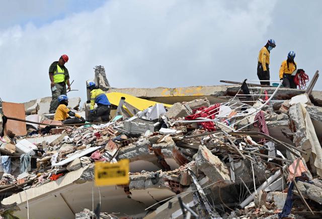 Rescuers work at the site of a collapsed building eight days after twin earthquakes, in Caraballeda, La Guaira state, Venezuela, on July 2, 2026,. More than a week after the earthquakes struck, there is little chance of finding additional survivors from the two earthquakes that killed nearly 2,300 people, destroyed entire residential buildings, and left tens of thousands missing. (Photo by MARTIN BERNETTI / AFP)