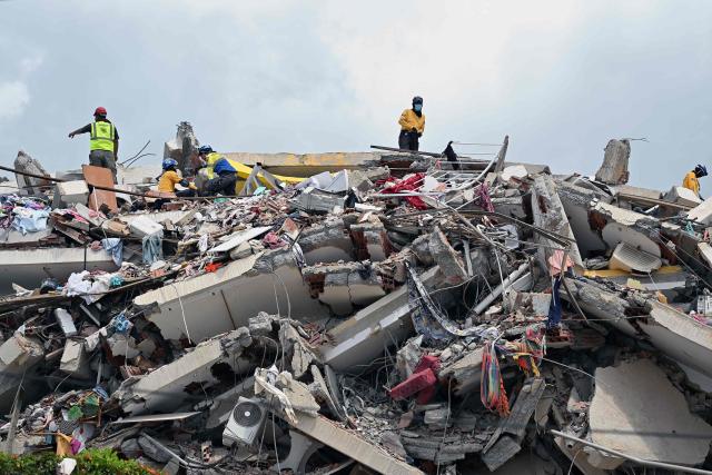 Rescuers work at the site of a collapsed building eight days after twin earthquakes, in Caraballeda, La Guaira state, Venezuela, on July 2, 2026,. More than a week after the earthquakes struck, there is little chance of finding additional survivors from the two earthquakes that killed nearly 2,300 people, destroyed entire residential buildings, and left tens of thousands missing. (Photo by MARTIN BERNETTI / AFP)