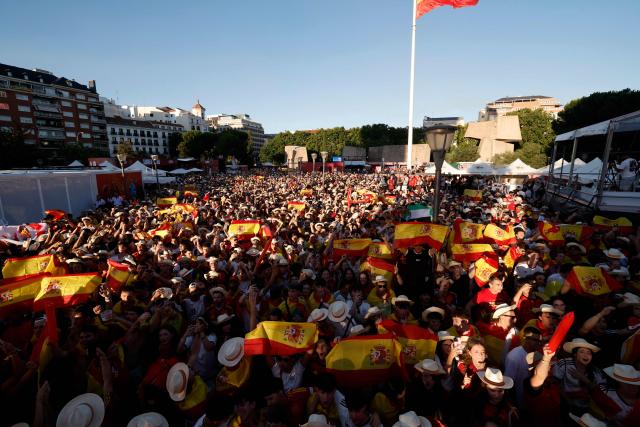 Spain supporters cheer while viewing giant screens showing the Spain vs. Austria FIFA World Cup 2026 round-of-32 football match at Los Angeles Stadium in Inglewood, as seen in Madrid on July 2, 2026. (Photo by Oscar DEL POZO / AFP)