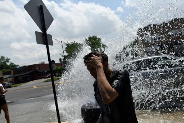 A person cools off with water from an open fire hydrant during a heat wave on the West Side of Chicago, Illinois, on July 2, 2026. Blistering temperatures and humidity gripped swaths of the United States on July 1, with the worst yet to come for the densely populated East Coast as the nation co-hosts the World Cup and prepares to celebrate its 250th birthday. "Heat dome" conditions -- in which high-pressure systems trap warm air like the lid on a pot -- persisted over the Midwest and South and were moving east, with some 46 million people under heat alerts. (Photo by OCTAVIO JONES / AFP)