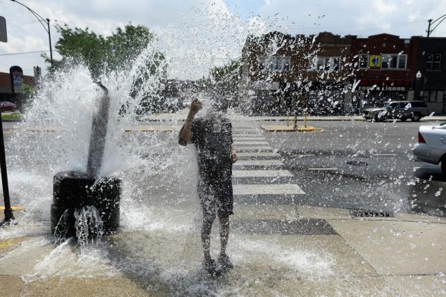 A person cools off with water from an open fire hydrant during a heat wave on the West Side of Chicago, Illinois, on July 2, 2026. Blistering temperatures and humidity gripped swaths of the United States on July 1, with the worst yet to come for the densely populated East Coast as the nation co-hosts the World Cup and prepares to celebrate its 250th birthday. "Heat dome" conditions -- in which high-pressure systems trap warm air like the lid on a pot -- persisted over the Midwest and South and were moving east, with some 46 million people under heat alerts. (Photo by OCTAVIO JONES / AFP)