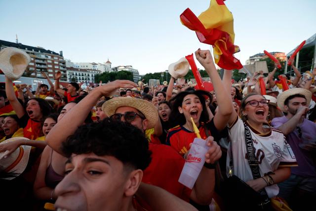 Spain supporters cheer while viewing giant screens showing the Spain vs. Austria FIFA World Cup 2026 round-of-32 football match at Los Angeles Stadium in Inglewood, as seen in Madrid on July 2, 2026. (Photo by Oscar DEL POZO / AFP)