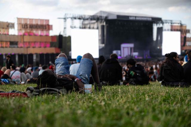 Festival-goers take part in the first day of the 19th edition edition of the Les Ardentes music festival in Liege on July 2, 2026. (Photo by EMILE WINDAL / Belga / AFP) / Belgium OUT