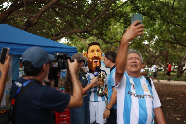 An Argentine fan wearing a costume depicting Argentine football player Lionel Messi gives an interview with the press during a gathering at Miami Beach in Miami on July 2, 2026, on the eve of the 2026 World Cup round of 32 football match between Argentina and Cape Verde. (Photo by PATRICIA DE MELO MOREIRA / AFP)