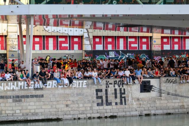 Austria supporters gather for a public screening of Austria's match against Spain played at the 2026 FIFA World Cup Los Angeles Stadium, Inglewood, USA, as they sit along the Danube Canal in Vienna on July 2, 2026. (Photo by MAX SLOVENCIK / APA / AFP) / Austria OUT