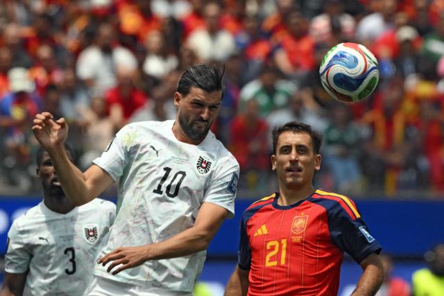 Austria's midfielder #10 Florian Grillitsch heads the ball past Spain's forward #21 Mikel Oyarzabal during the 2026 World Cup round of 32 football match between Spain and Austria at the Los Angeles Stadium in Inglewood on July 2, 2026.  (Photo by Patrick T. Fallon / AFP)