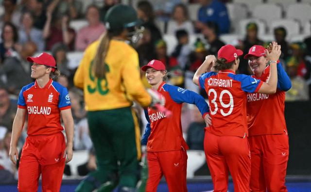 England's Sophie Ecclestone (R) celebrates catching the ball to take the wicket of South Africa's Suné Luus for 11 runs during the ICC Women's Twenty20 (T20) cricket world cup 2026 semi-final game between England and South Africa, at The Oval in London on July 2, 2026. (Photo by JUSTIN TALLIS / AFP)