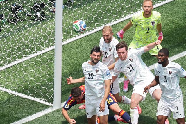 Austria's midfielder #10 Florian Grillitsch, midfielder #20 Konrad Laimer, forward #11 Michael Gregoritsch, goalkeeper #01 Alexander Schlager, and defender #03 Kevin Danso look at the ball past Spain's defender #14 Aymeric Laporte during the 2026 World Cup round of 32 football match between Spain and Austria at the Los Angeles Stadium in Inglewood on July 2, 2026.  (Photo by VALERIE MACON / AFP)