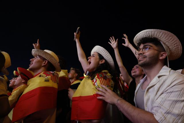 Spain supporters celebrate Spain's second goal while watching the Spain vs. Austria FIFA World Cup 2026 round-of-32 football match on giant screens in Madrid on July 2, 2026. (Photo by Oscar DEL POZO / AFP)