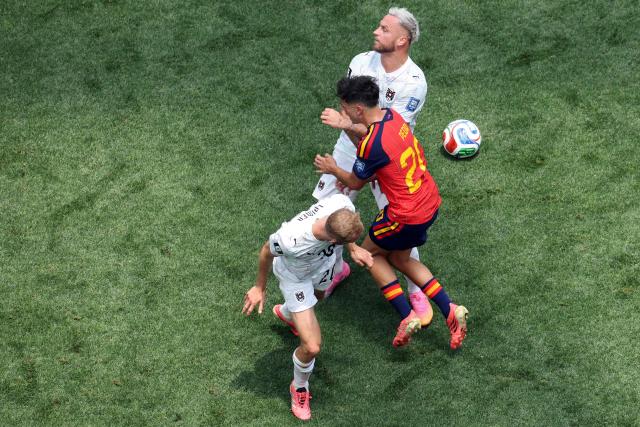 Spain's midfielder #20 Pedri (C) fights for the ball with Austria's midfielder #20 Konrad Laimer and forward #07 Marko Arnautovic during the 2026 World Cup round of 32 football match between Spain and Austria at the Los Angeles Stadium in Inglewood on July 2, 2026.  (Photo by VALERIE MACON / AFP)