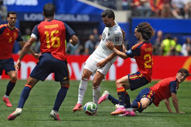 Austria's midfielder #10 Florian Grillitsch, Spain's defender #24 Marc Cucurella, and midfielder #09 Gavi fight for the ball during the 2026 World Cup round of 32 football match between Spain and Austria at the Los Angeles Stadium in Inglewood on July 2, 2026.  (Photo by Patrick T. Fallon / AFP)