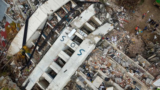 This aerial photograph taken on July 2, 2026 in Caraballeda in the state of La Guaira shows collapsed buildings following the June 24 twin earthquakes. More than a week after the earthquakes struck, there is little chance of finding additional survivors from the two earthquakes that killed nearly 2,300 people, destroyed entire residential buildings, and left tens of thousands missing. (Photo by Miguel MEDINA / POOL / AFP)