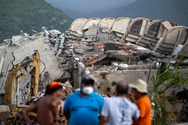 This photograph taken on July 2, 2026 in Caraballeda in the state of La Guaira shows volunteers collapsed buildings following the June 24 twin earthquakes. More than a week after the earthquakes struck, there is little chance of finding additional survivors from the two earthquakes that killed nearly 2,300 people, destroyed entire residential buildings, and left tens of thousands missing. (Photo by Miguel MEDINA / POOL / AFP)