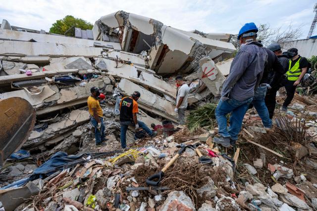 This photograph taken on July 2, 2026 in Caraballeda in the state of La Guaira shows volunteers looking for survivors in a collapsed building following the June 24 twin earthquakes. More than a week after the earthquakes struck, there is little chance of finding additional survivors from the two earthquakes that killed nearly 2,300 people, destroyed entire residential buildings, and left tens of thousands missing. (Photo by Miguel MEDINA / POOL / AFP)
