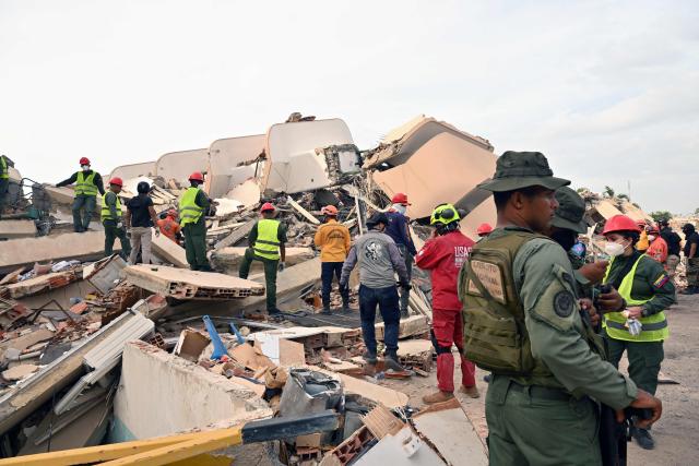 Rescuers search for survivors among the rubble of a collapsed building in Caraballeda, La Guaira state, Venezuela, on July 2, 2026, eight days after twin earthquakes. Hundreds of rescuers in Venezuela cheered and embraced on July 2, 2026 after pulling 43-year-old Hernan Gil from the ruins of a collapsed building eight days after deadly twin earthquakes, AFP journalists witnessed. (Photo by MARTIN BERNETTI / AFP)