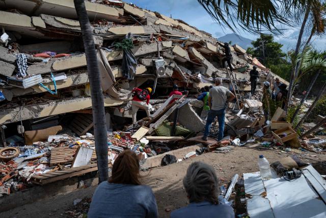 This photograph taken on July 2, 2026 in Caraballeda in the state of La Guaira shows volunteers looking for survivors in a collapsed building following the June 24 twin earthquakes. More than a week after the earthquakes struck, there is little chance of finding additional survivors from the two earthquakes that killed nearly 2,300 people, destroyed entire residential buildings, and left tens of thousands missing. (Photo by Miguel MEDINA / POOL / AFP)