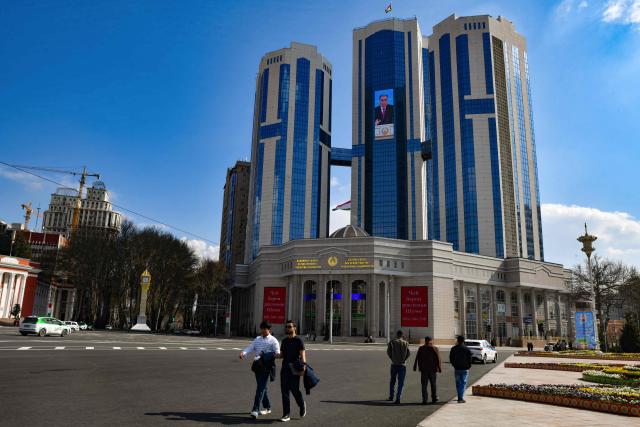 (FILES) A screen displaying a portrait of Tajikistan's President Emomali Rakhmon sits on a modern administrative building in the Tajik capital of Dushanbe on March 20, 2026. (Photo by AFP)