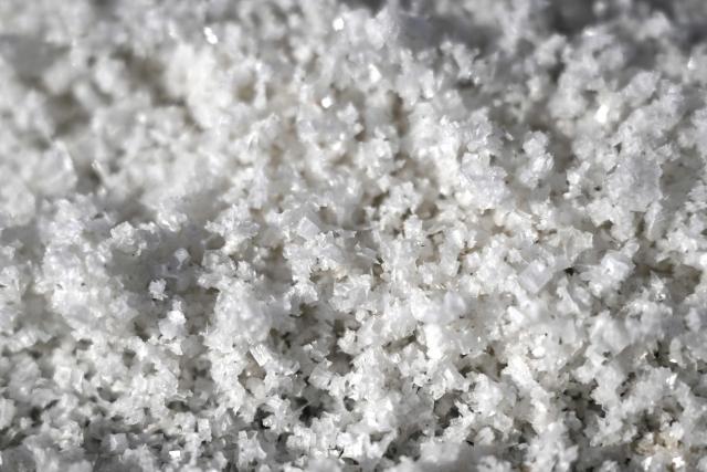 This photograph shows salt flower from a basin of a salt marsh in Chateau-d'Olйron, on the Oleron Island, western France on June 17, 2026. The profession of salt worker, which disappeared from Olйron Island in the 1980s, was reintroduced with the support of local authorities because salt marshes, as “buffer” zones, can absorb part of the marine flooding, which is becoming increasingly frequent with climate change. (Photo by Christophe ARCHAMBAULT / AFP)