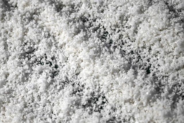 This photograph shows salt flower from a basin of a salt marsh in Chateau-d'Olйron, on the Oleron Island, western France on June 17, 2026. The profession of salt worker, which disappeared from Olйron Island in the 1980s, was reintroduced with the support of local authorities because salt marshes, as “buffer” zones, can absorb part of the marine flooding, which is becoming increasingly frequent with climate change. (Photo by Christophe ARCHAMBAULT / AFP)