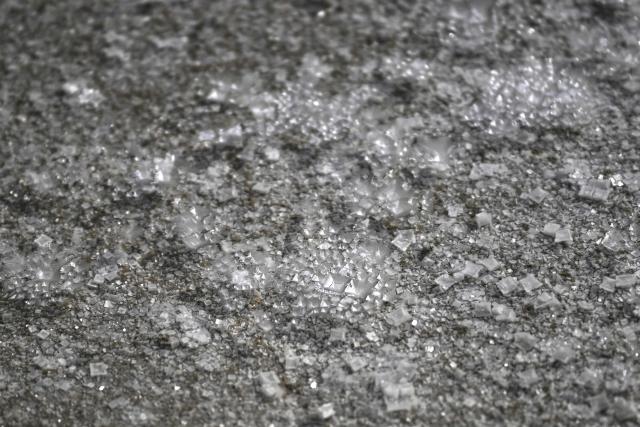 This photograph shows salt flower from a basin of a salt marsh in Chateau-d'Olйron, on the Oleron Island, western France on June 17, 2026. The profession of salt worker, which disappeared from Olйron Island in the 1980s, was reintroduced with the support of local authorities because salt marshes, as “buffer” zones, can absorb part of the marine flooding, which is becoming increasingly frequent with climate change. (Photo by Christophe ARCHAMBAULT / AFP)