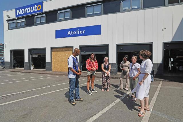 Norauto HR managers explain garage operations to former inmates during a "Day at Norauto" event, organized by M6 Foundation, in Villeneuve-d'Ascq on June 24, 2026. The scene takes place at Norauto, where six former inmates took part in a day-long event organized in late June by the M6 Foundation, which works to help people under judicial supervision reintegrate into society. For participating companies, these events also help address recruitment challenges in certain fields. (Photo by Francois LO PRESTI / AFP)