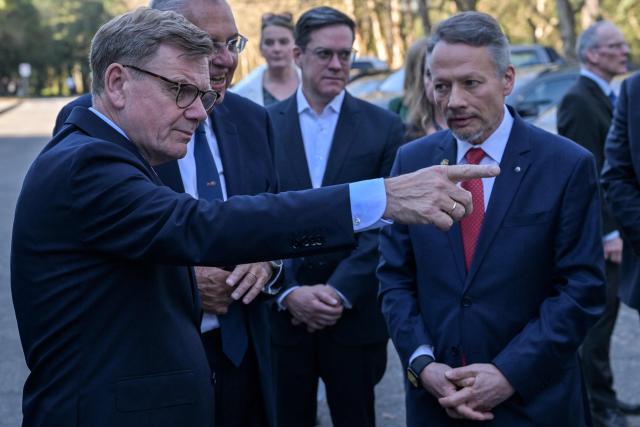 German Foreign Minister Johann Wadephul (L) gestures next to Volkswagen Chief Executive Officer Ciro Possobom (R) during a visit to the Volkswagen plant in Sao Bernardo do Campo, Sao Paulo state, Brazil, on July 2, 2026. (Photo by Nelson ALMEIDA / AFP)