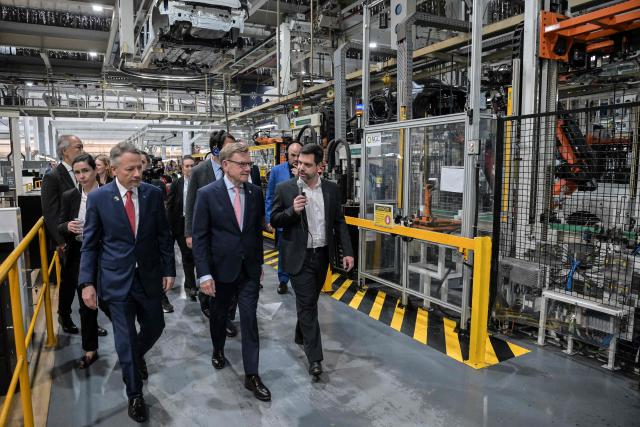 German Foreign Minister Johann Wadephul (C) walks next to Volkswagen Chief Executive Officer Ciro Possobom (L) during a visit to the Volkswagen plant in Sao Bernardo do Campo, Sao Paulo state, Brazil, on July 2, 2026. (Photo by Nelson ALMEIDA / AFP)