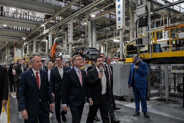 German Foreign Minister Johann Wadephul (C) walks next to Volkswagen Chief Executive Officer Ciro Possobom (L) during a visit to the Volkswagen plant in Sao Bernardo do Campo, Sao Paulo state, Brazil, on July 2, 2026. (Photo by Nelson ALMEIDA / AFP)