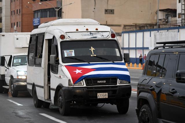 A van carrying Cuban medical personnel drives in a street in La Guaira, La Guaira state, Venezuela, on July 2, 2026, eight days after twin earthquakes. Hundreds of rescuers in Venezuela cheered and embraced on July 2, 2026 after pulling 43-year-old Hernan Gil from the ruins of a collapsed building eight days after deadly twin earthquakes, AFP journalists witnessed. (Photo by Juan BARRETO / AFP)