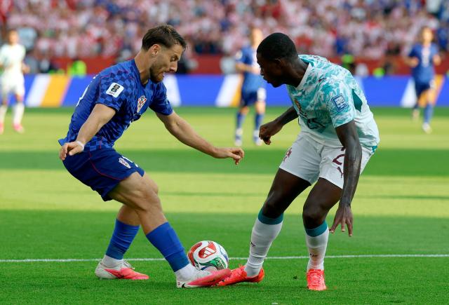 Portugal's defender #25 Nuno Mendes and Croatia's midfielder #13 Nikola Vlasic fight for the ball during the 2026 World Cup round of 32 football match between Portugal and Croatia at the Toronto Stadium in Toronto on July 2, 2026.  (Photo by Kamil Krzaczynski / AFP)