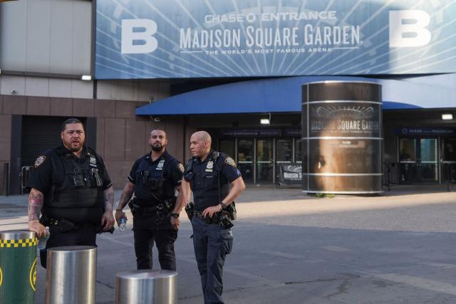New York City police officers stand guard outside Madison Square Garden in Manhattan, New York on July 2, 2026. Increasing signs point to a mega-bash for the A-list celebrity couple Taylor Swift and Travis Kelce at Madison Square Garden kicking off on July 2, 2026 with a rehearsal dinner. Rumors have run rampant for weeks that the 36-year-old pop superstar and the three-time NFL Super Bowl winner, also 36, could wed at the storied sports arena, home to the New York Knicks, the newly crowned NBA champions. (Photo by Ryan MURPHY / AFP)