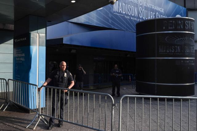 A New York City police officer stands guard outside Madison Square Garden in Manhattan, New York on July 2, 2026. Increasing signs point to a mega-bash for the A-list celebrity couple Taylor Swift and Travis Kelce at Madison Square Garden kicking off on July 2, 2026 with a rehearsal dinner. Rumors have run rampant for weeks that the 36-year-old pop superstar and the three-time NFL Super Bowl winner, also 36, could wed at the storied sports arena, home to the New York Knicks, the newly crowned NBA champions. (Photo by Ryan MURPHY / AFP)