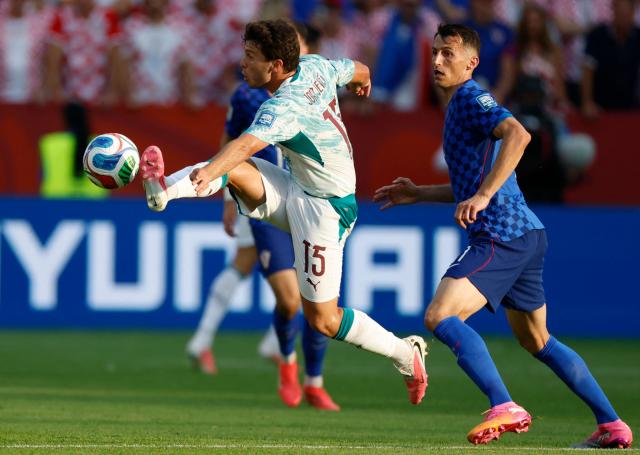 Portugal's midfielder #15 Joao Neves and Croatia's forward #11 Ante Budimir fight for the ball during the 2026 World Cup round of 32 football match between Portugal and Croatia at the Toronto Stadium in Toronto on July 2, 2026.  (Photo by Kamil Krzaczynski / AFP)