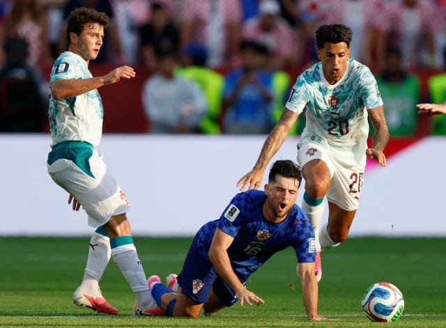 Portugal's midfielder #15 Joao Neves, defender #20 Joao Cancelo and Croatia's midfielder #16 Martin Baturina fight for the ball during the 2026 World Cup round of 32 football match between Portugal and Croatia at the Toronto Stadium in Toronto on July 2, 2026.  (Photo by Kamil Krzaczynski / AFP)