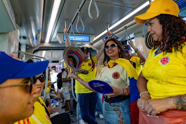 Colombian fans ride on the subway to take part in a "banderazo" flag-waving gathering at Mill Creek Park in Kansas City on July 2, 2026, on the eve of the 2026 World Cup round of 32 football match between Colombia and Ghana. (Photo by Odd Andersen / AFP)