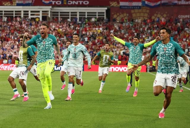 Portugal's forward #07 Cristiano Ronaldo celebrates with teammates after his team scored their second goal during the 2026 World Cup round of 32 football match between Portugal and Croatia at the Toronto Stadium in Toronto on July 2, 2026.  (Photo by Cole Burston / AFP)