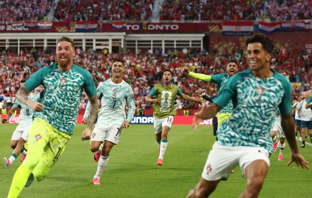 Portugal's forward #07 Cristiano Ronaldo celebrates with teammates after his team scored their second goal during the 2026 World Cup round of 32 football match between Portugal and Croatia at the Toronto Stadium in Toronto on July 2, 2026.  (Photo by Cole Burston / AFP)