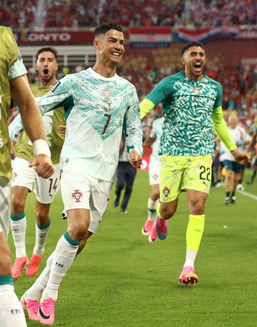 Portugal's forward #07 Cristiano Ronaldo celebrates with teammates after his team scored their second goal during the 2026 World Cup round of 32 football match between Portugal and Croatia at the Toronto Stadium in Toronto on July 2, 2026.  (Photo by Cole Burston / AFP)