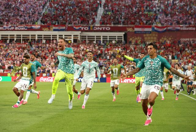 Portugal's forward #07 Cristiano Ronaldo celebrates with teammates after his team scored their second goal during the 2026 World Cup round of 32 football match between Portugal and Croatia at the Toronto Stadium in Toronto on July 2, 2026.  (Photo by Cole Burston / AFP)