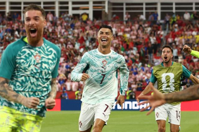 Portugal's forward #07 Cristiano Ronaldo celebrates with teammates after his team scored their second goal during the 2026 World Cup round of 32 football match between Portugal and Croatia at the Toronto Stadium in Toronto on July 2, 2026.  (Photo by Cole Burston / AFP)