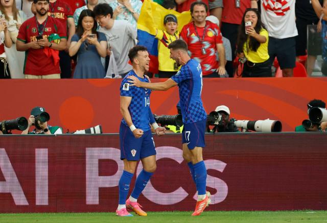 Croatia's forward #14 Ivan Perisic celebrates with teammate midfielder #17 Petar Sucic after scoring his team's first goal during the 2026 World Cup round of 32 football match between Portugal and Croatia at the Toronto Stadium in Toronto on July 2, 2026.  (Photo by Kamil Krzaczynski / AFP)