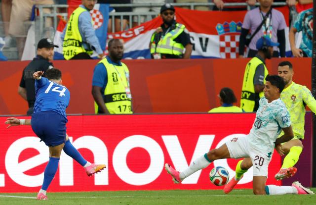 Croatia's forward #14 Ivan Perisic scores his team's first goal during the 2026 World Cup round of 32 football match between Portugal and Croatia at the Toronto Stadium in Toronto on July 2, 2026.  (Photo by Kamil Krzaczynski / AFP)